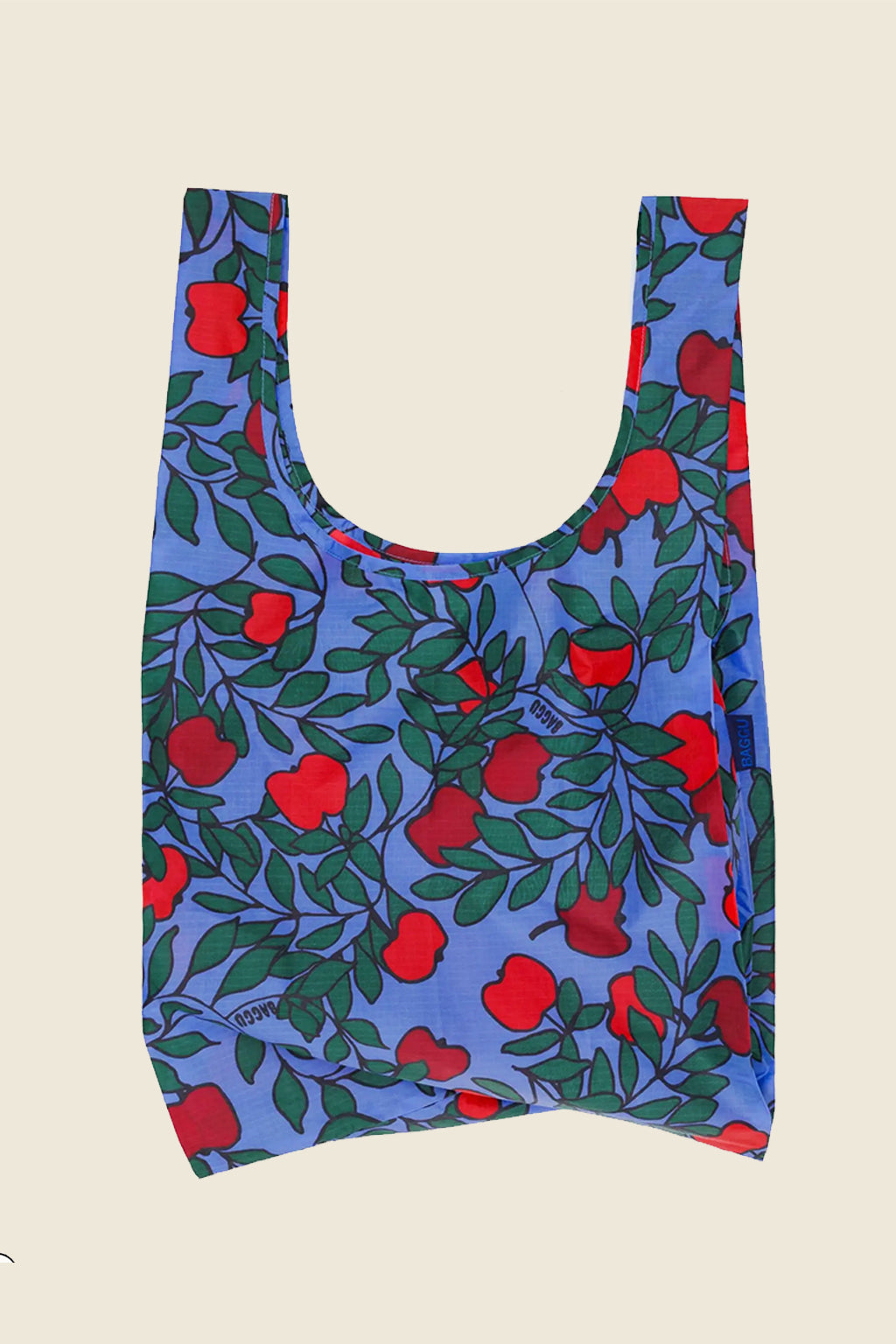 Kin Ship Goods Apple Tree Baggu with red apples and green leaves on blue background reusable shopping tote
