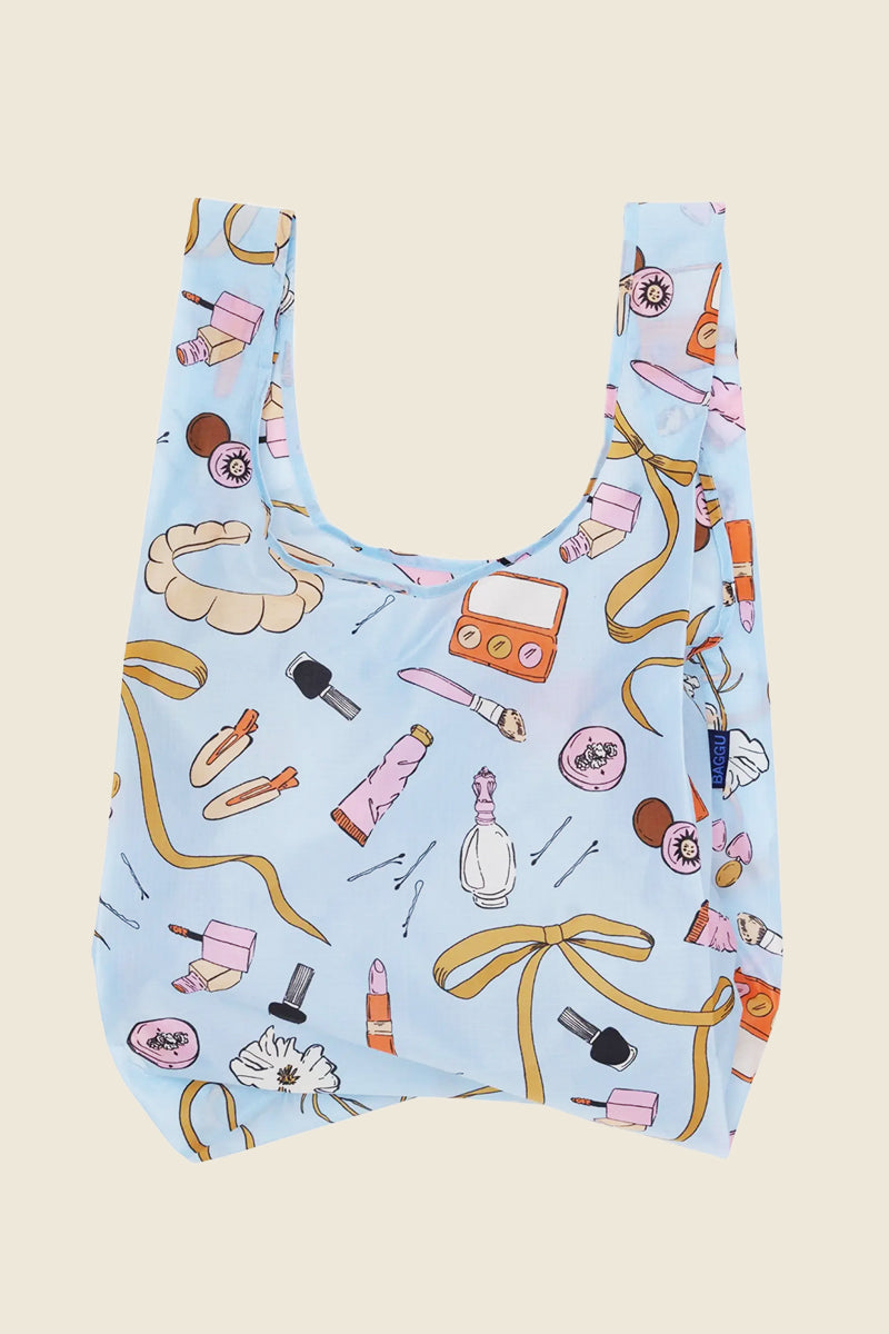 Kin Ship Goods BAGGU Standard Reusable Bag in pastel Beauty Print with lipsticks and compacts, made from recycled nylon