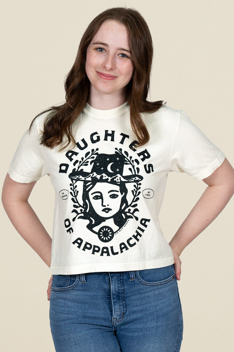 Kin Ship Goods Daughters of Appalachia tee in cream with bold black graphic, modeled with a relaxed fit and casual style.
