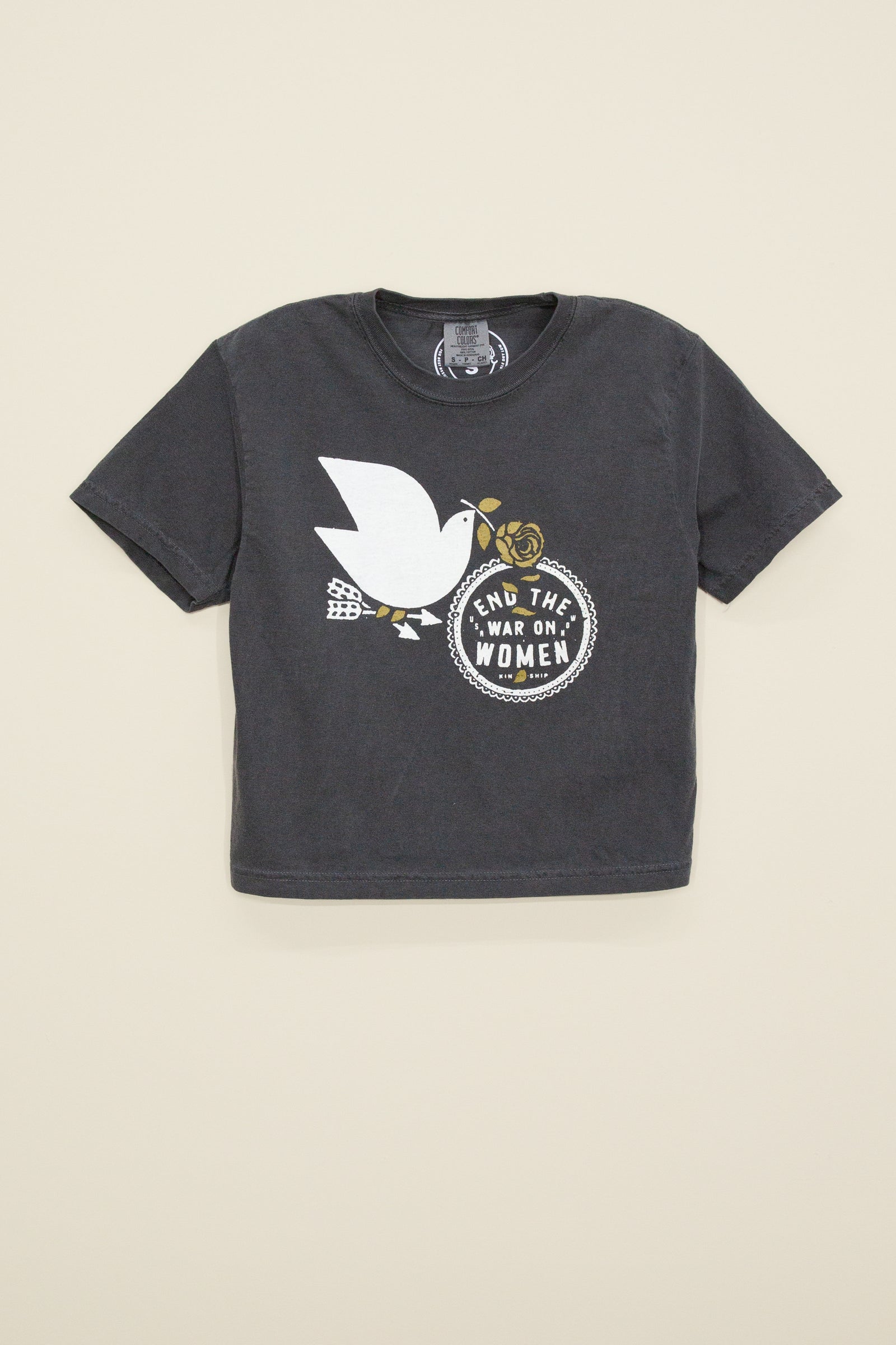 End the War on Women cropped tee from Kin Ship Goods – vintage-wash black shirt featuring a peace dove and bold feminist message. Ethically made.