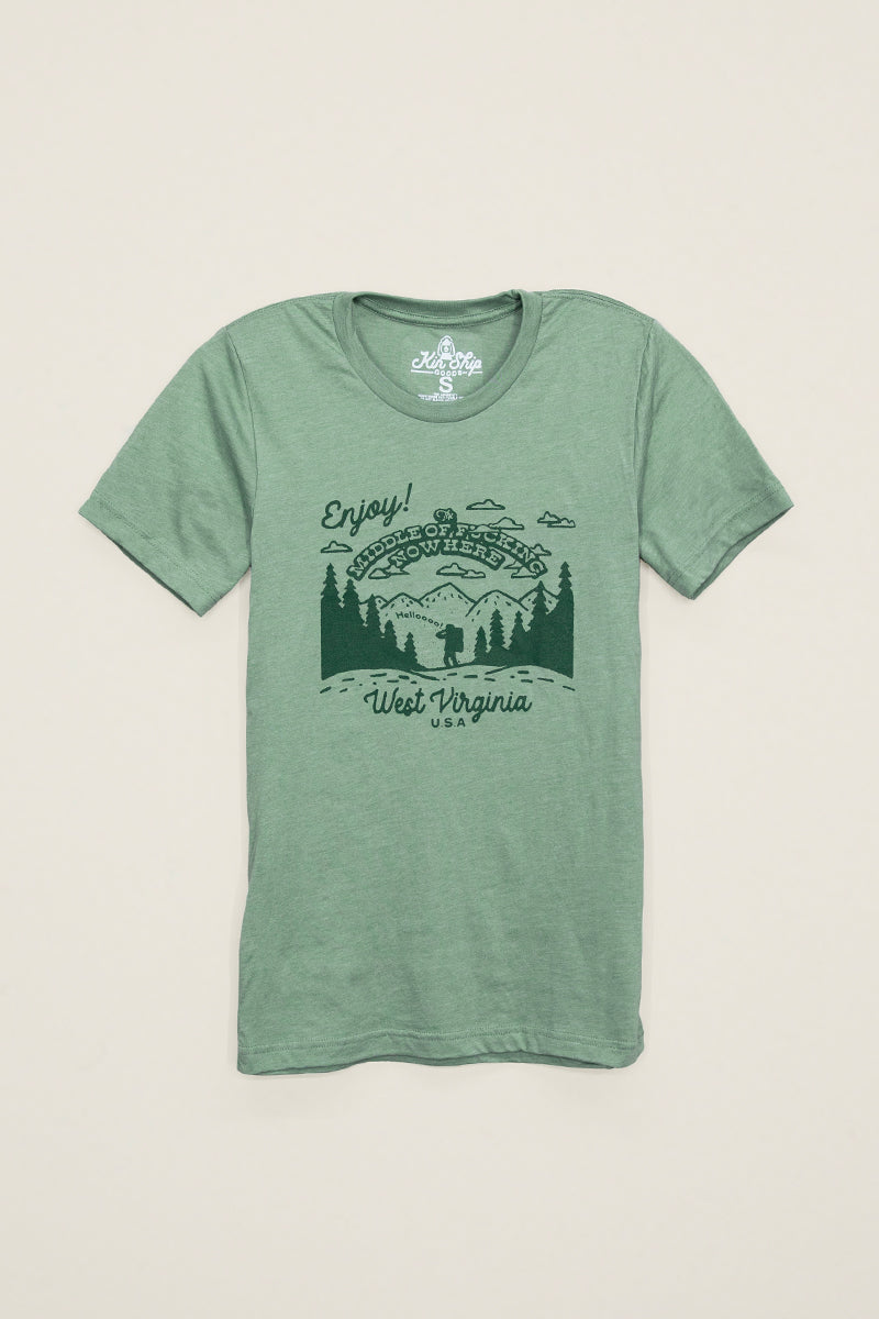 Kin Ship Goods green tee with forest scene and ‘Middle of Nowhere, West Virginia USA’ graphic, perfect for outdoor lovers.