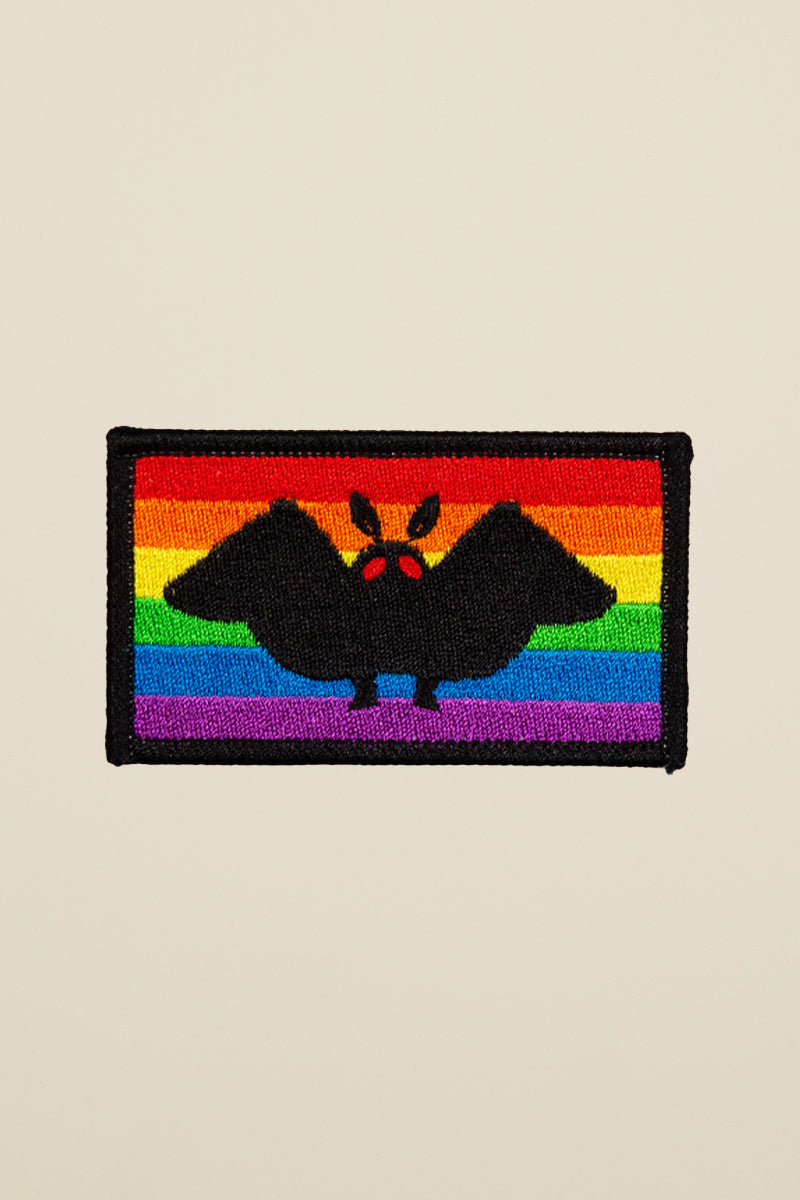 Kin Ship Goods Mothman Pride Patch with rainbow flag background, made from recycled bottles with iron-on back