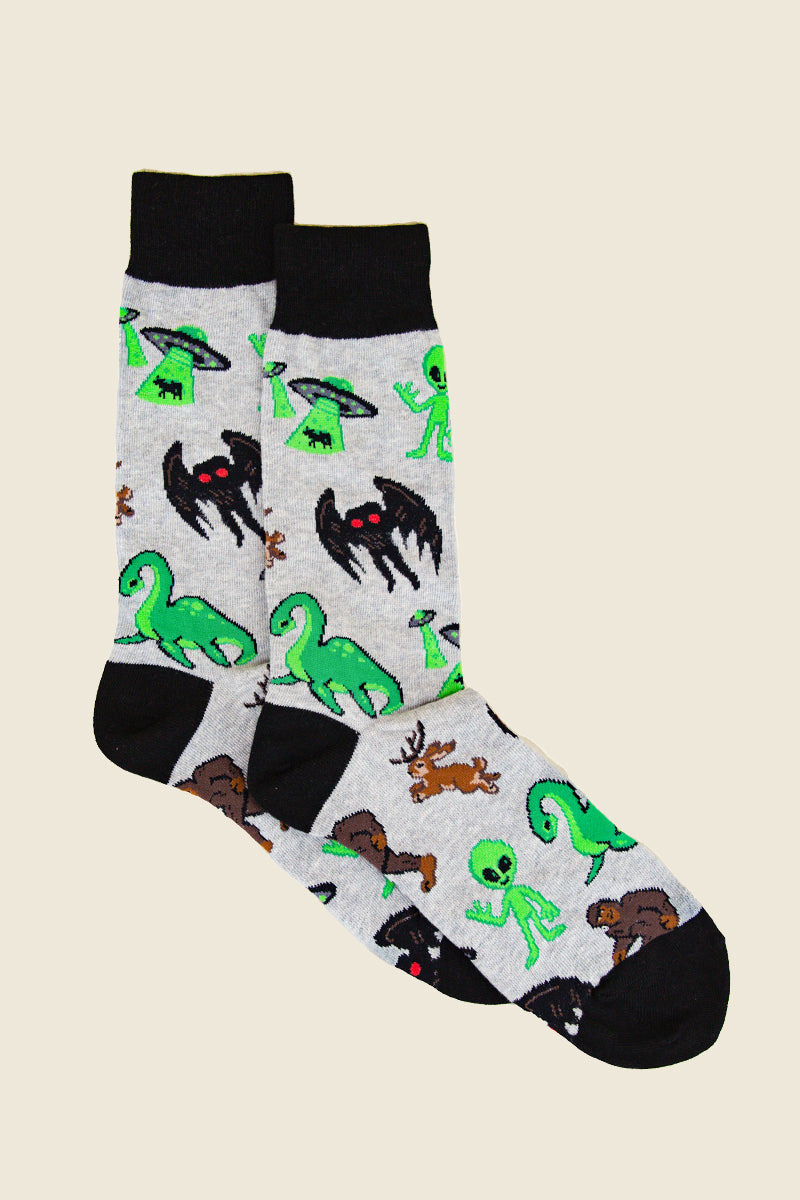 Kin Ship Goods cryptid socks with aliens, Mothman, Bigfoot, and Nessie on heather gray—crew socks for cryptid lovers and believers.