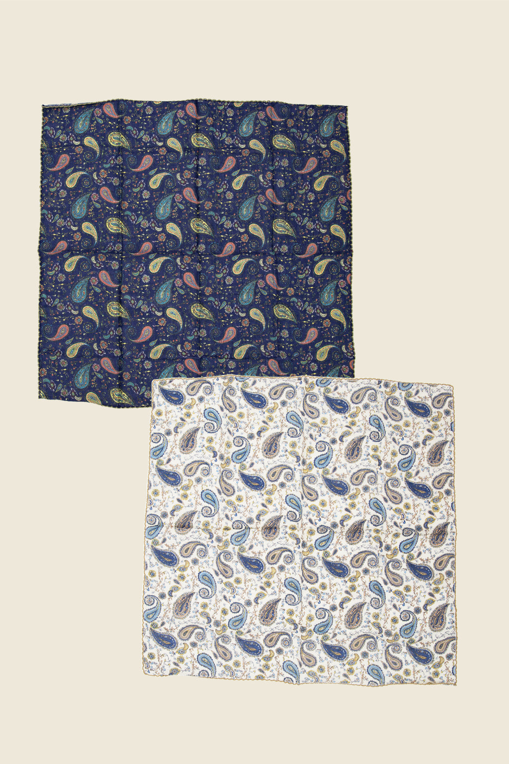 Two patterned paisley bandanas on a beige background. Sold by Kin Ship Goods.
