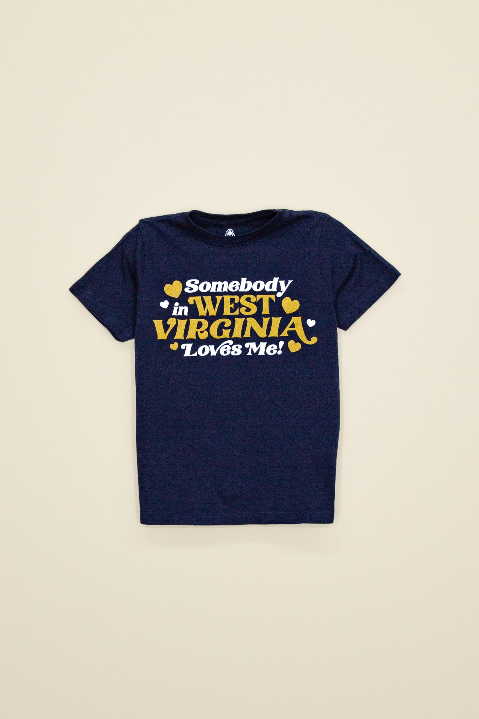 Kin Ship Goods navy kids tee with gold and white ‘Somebody in West Virginia Loves Me!’ retro-style graphic and hearts.
