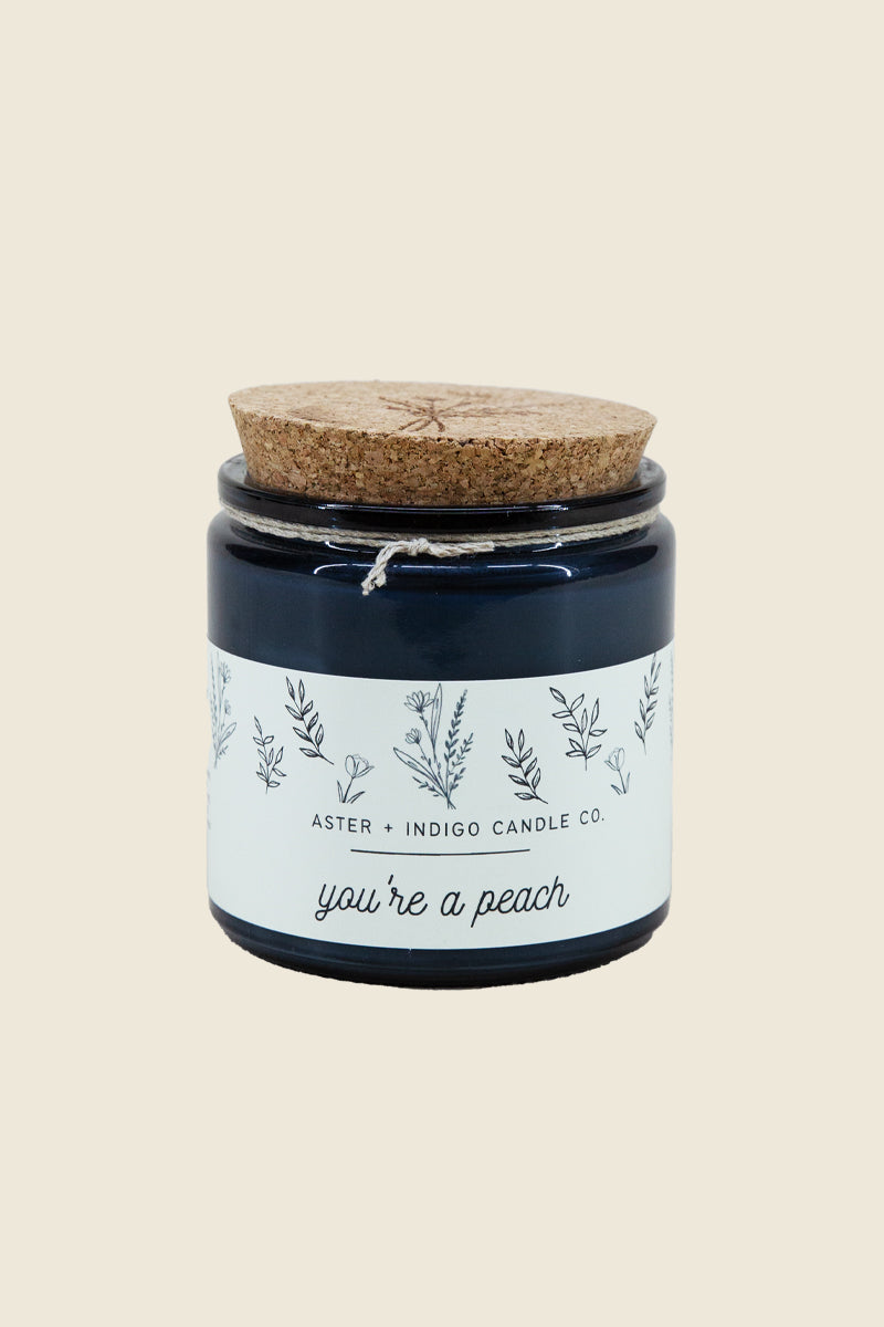 Kin Ship Goods peach cream candle with sweet lemon, praline, and summer fruit notes in a hand-poured soy jar.